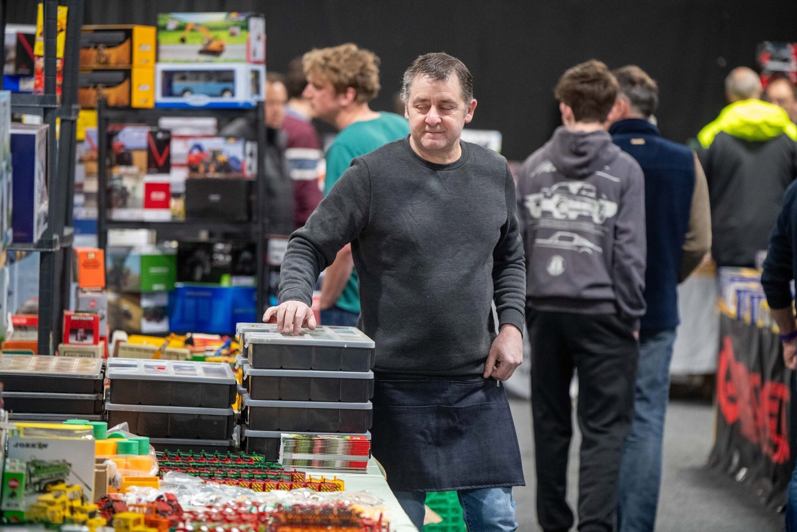 Trader behind a stand stacked with boxed model tractors at the Spalding Model Tractor Show
