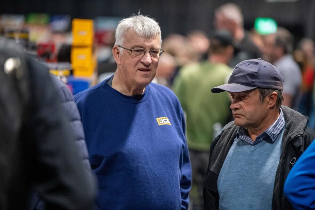 Two visitors chatting beside a trade stand at the Spalding Model Tractor Show