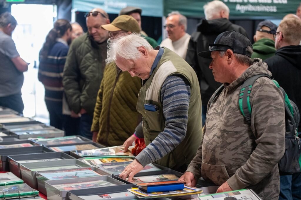 Collectors browsing boxed diecast farm models at a trader's stand, Spalding Model Tractor Show