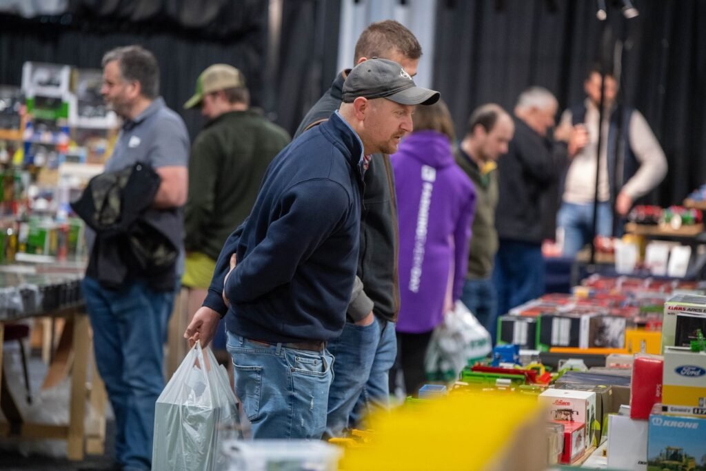 Visitors browsing boxed farm models on a trade stand at the Spalding Model Tractor Show