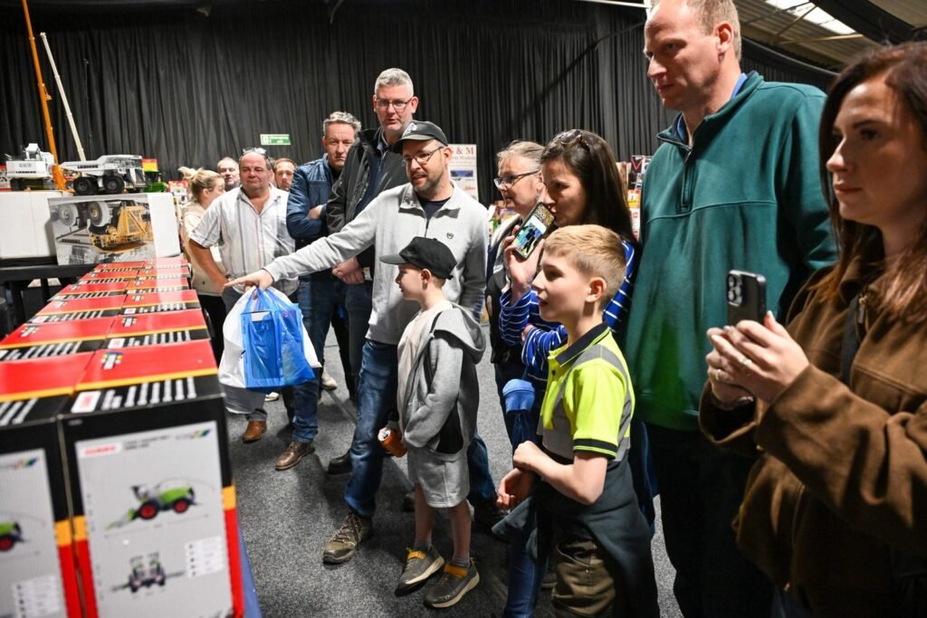 Families looking over a display of model tractors and farm machinery at the Spalding Model Tractor Show