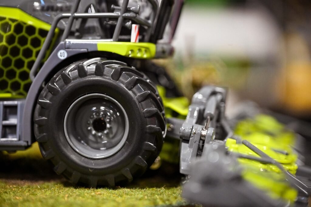 Close-up of the rear wheel and linkage on a green 1:32 scale model tractor at the Spalding Model Tractor Show