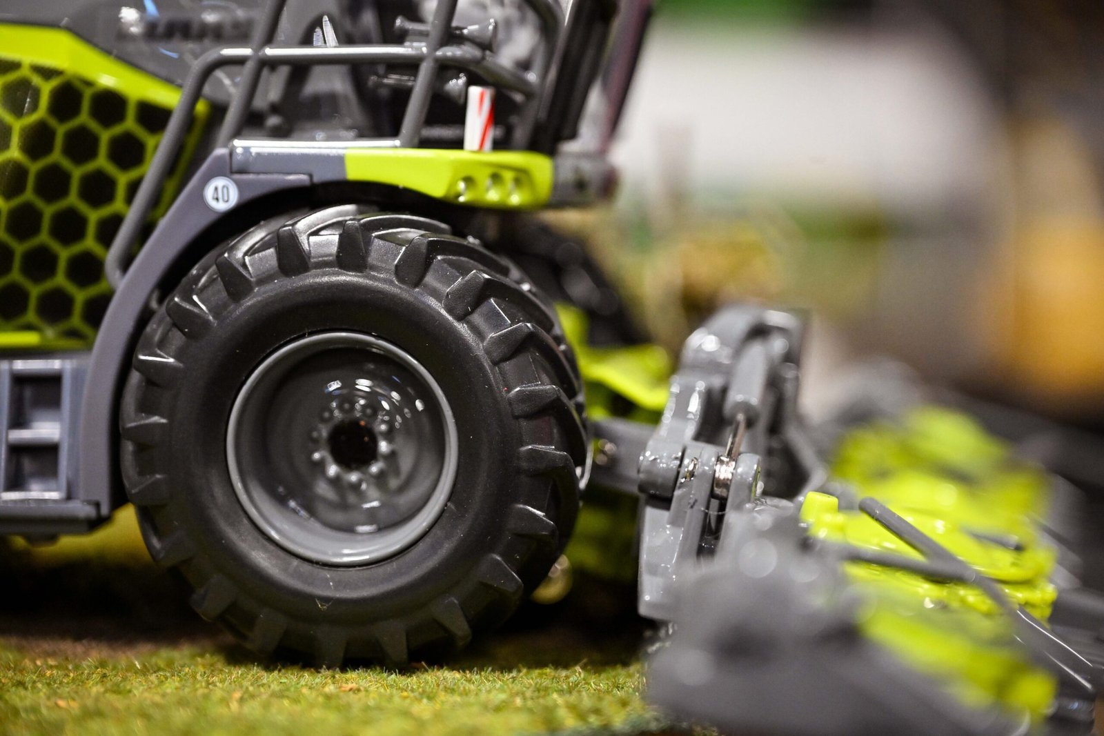 Close-up of the rear wheel and linkage on a green 1:32 scale model tractor at the Spalding Model Tractor Show