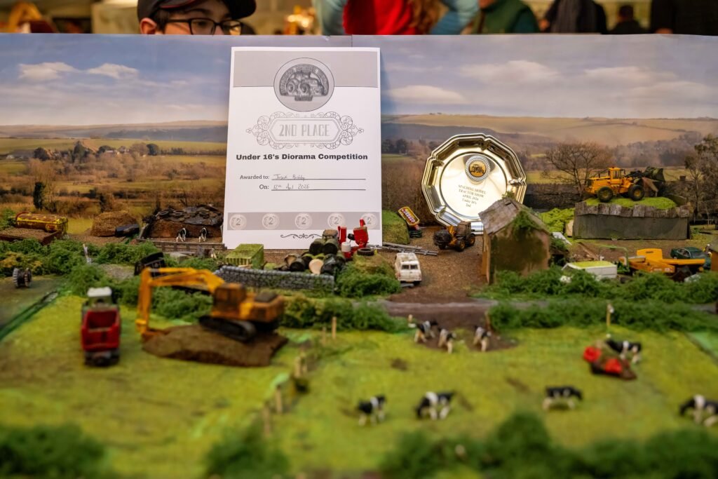 A prize-winning diorama beside its certificate and trophy in the show competition