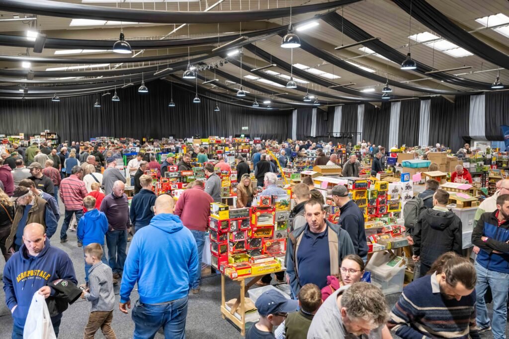 Visitors filling the hall at Springfields, with rows of trade tables covered in model tractors