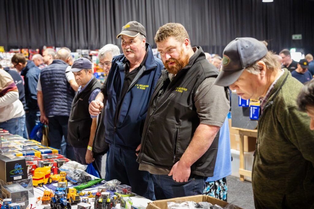 Collectors browsing a busy stand of boxed farm models at the Spalding Model Tractor Show
