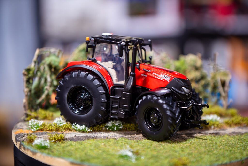 Red Case IH tractor model displayed on a grass diorama base at the Spalding Model Tractor Show