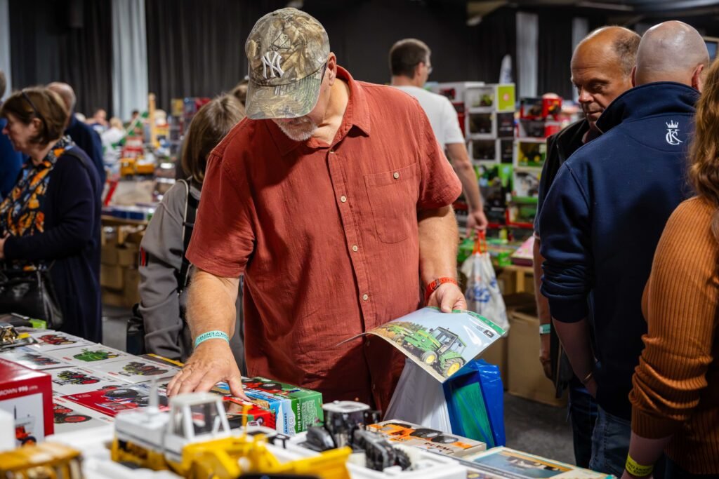Visitor looking through a model catalogue at a trade stand, Spalding Model Tractor Show