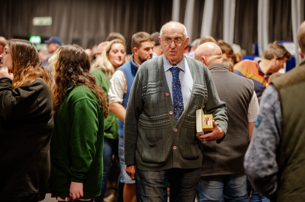 A collector examining a boxed model in the crowd