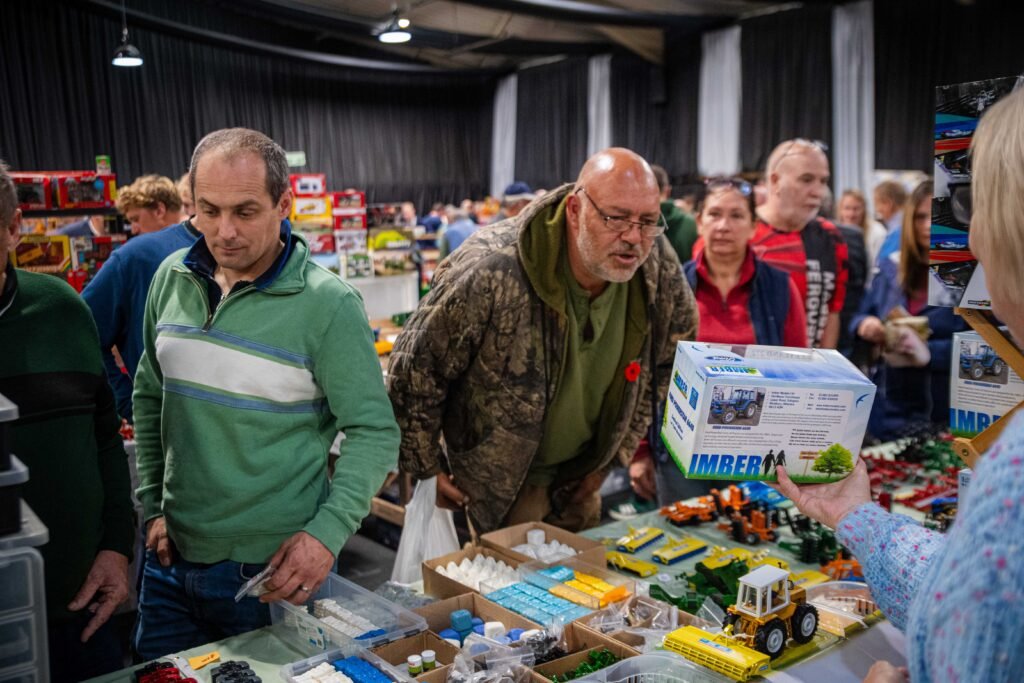 Visitors choosing from boxed models on a trade stand